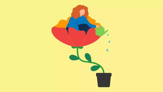 person sitting in a growing flower, as they're watering the pot from above