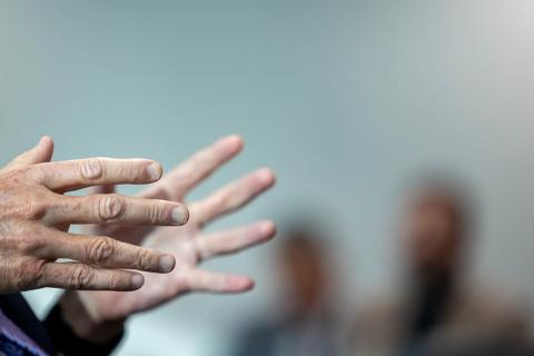 Caregiver's hands in meeting