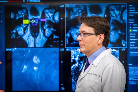 Dr. Purysko stands in front of prostate imaging screens