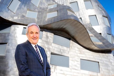 Larry Ruvo standing in front of the Cleveland Clinic Lou Ruvo Center for Brain Health