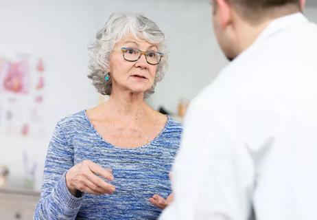 older woman talks with doctor about heart treatment