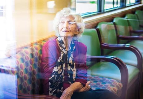 Senior woman sitting in waiting room at doctor office