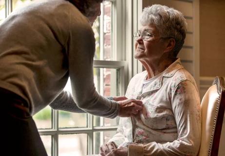 Daughter taking care of her elderly mother at home