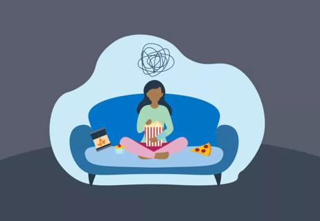 girl sad sitting on couch and eating junk food