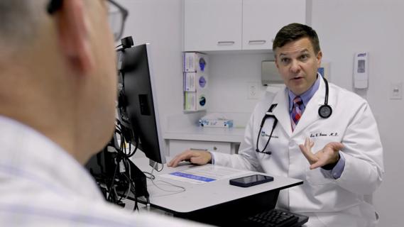 Eric Boose, M.D., uses AI software to document a patient appointment.