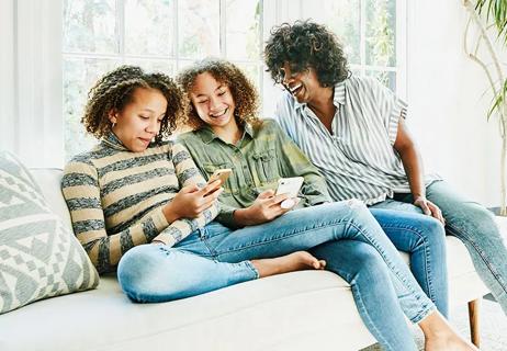 mother and daughters on couch at home