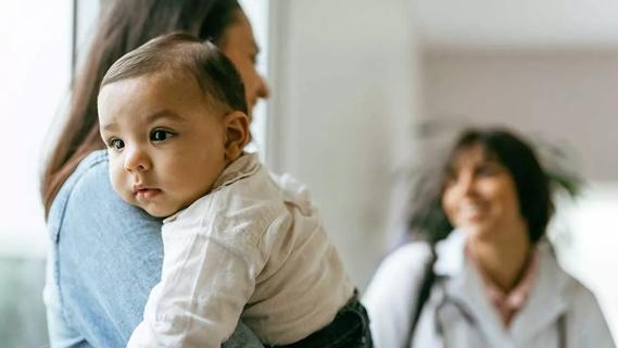 parent holding baby at a doctor's appointment