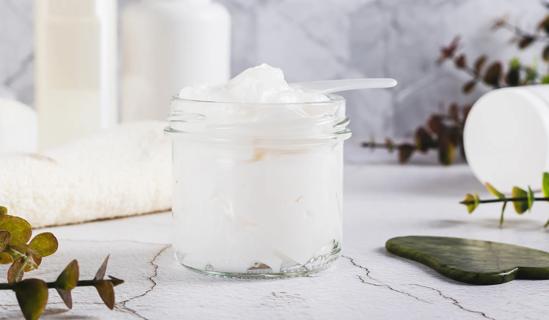 Beef tallow in jar on counter, with spatula