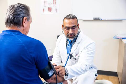 Physician taking patient's blood pressure