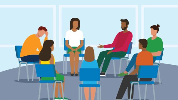 People sitting in an in-person support group talking