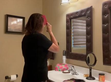 Woman brushing wet hair