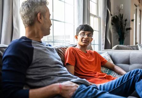 teen with parent talk on couch