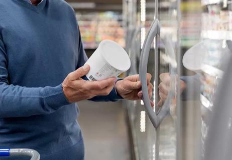 person reading a yogurt cup label