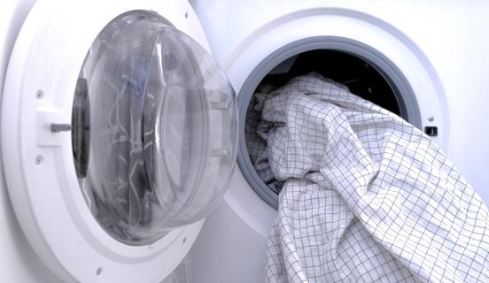 Clean sheets hanging out of dryer