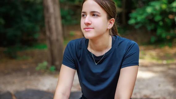 teenage girl in a wooded outdoor setting