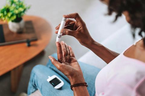 Person pricking their finger for a blood glucose test