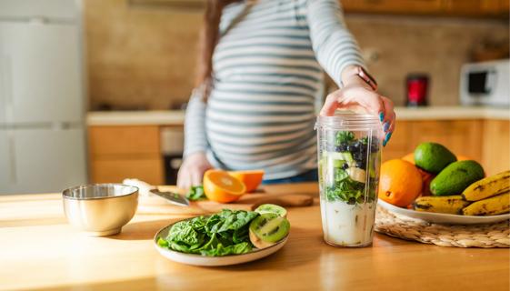 Someone who's pregnant making a healthy smoothie