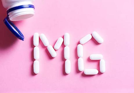 magnesium pills out of container spelling out MG