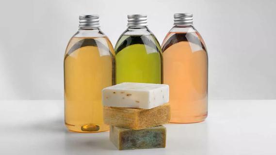 three bars of castille soap in front of three bottles of castille liquid soap