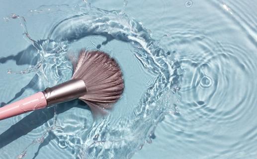Rinsing clean makeup brush in water