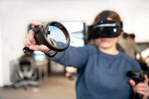 Young girl using augmented reality (AR) headset.