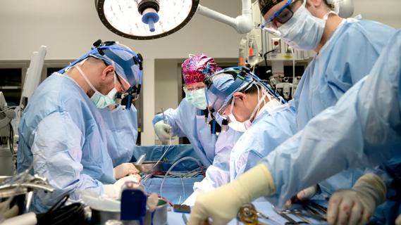 surgical team working at an operating table