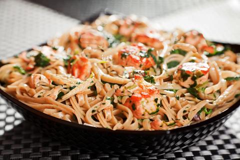 Bowl of seasoned Asian noodles with salmon