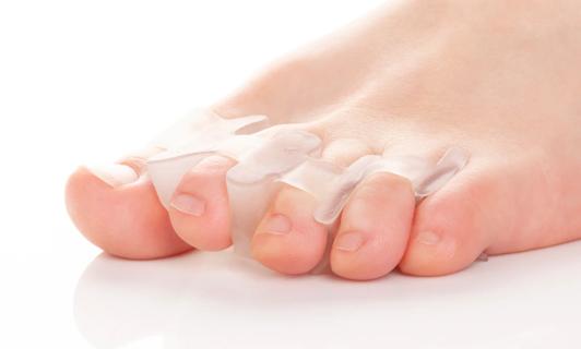 Foot with a toe spacer between toes