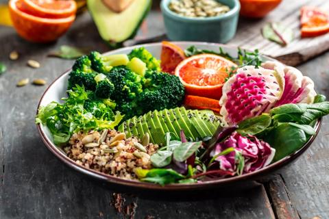 Plate full of colorful and healthy fruits, veggies and grains