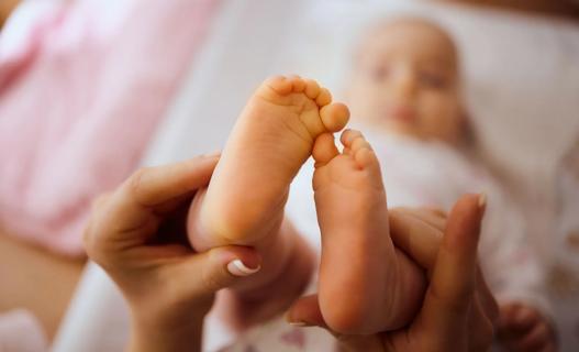 Baby's feet with a yellow-orange hue