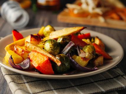 Plate of roasted winter vegetables, with Brussels sprouts, peppers , onions