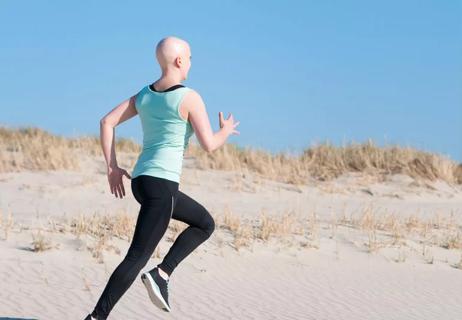 Cancer patient running on the beach
