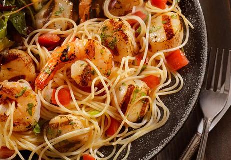 A closeup of pasta with shrimp
