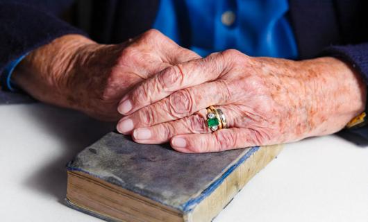 woman's hands with age spots holding bible