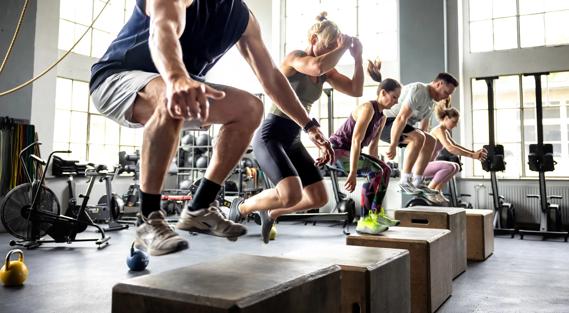 People doing box jumps at gym