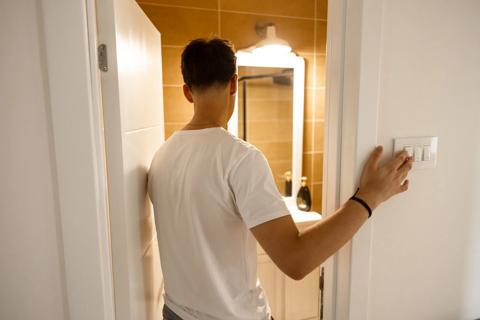 Teen walking into bathroom at home