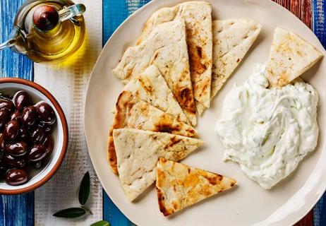 Turkish cucumber dip with pita chips and olives