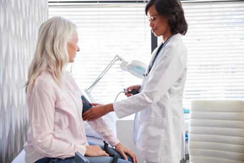 Healthcare provider taking patient's blood pressure