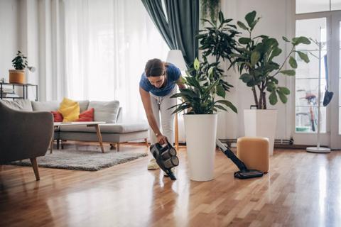 Person vacuuming around living room