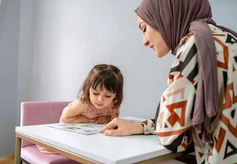 Mother helping child with homework.