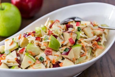 Large bowl of holiday cabbage slaw with apples and cranberries