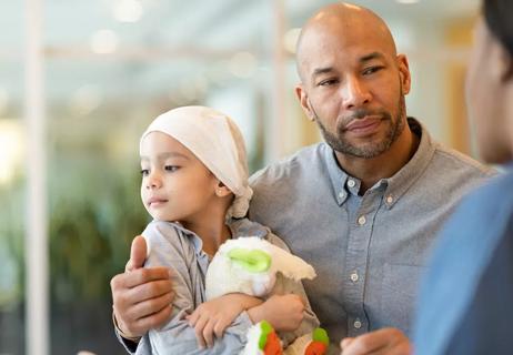 Father with daughter who has undergone cancer treatment