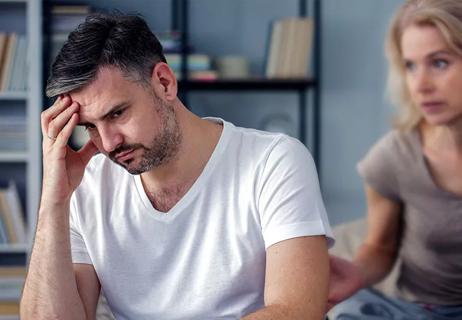 older man upset in bed with wife