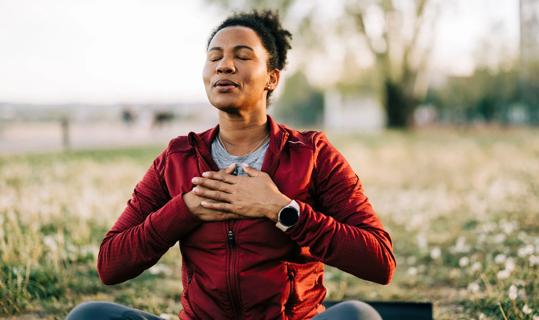 Woman meditating outside