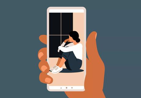 Someone holds up a smartphone and on the screen, there's a picture of a sad person looking out a window.