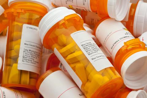 Several Prescription Pill Bottles in a Pile