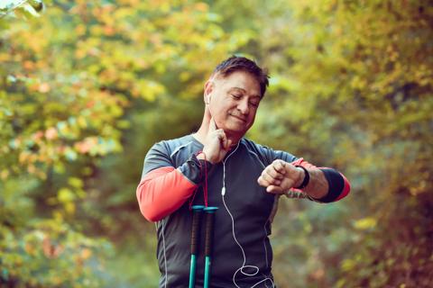 Person with workout gear, pausing to check their pulse