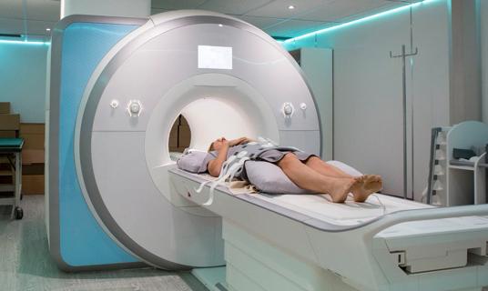 Person lying on MRI table, ready to enter the MRI machine