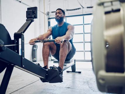 Person using rowing machine in home gym