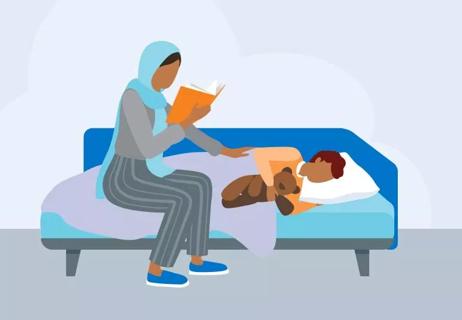 Parent reading to their sick child who is in bed.